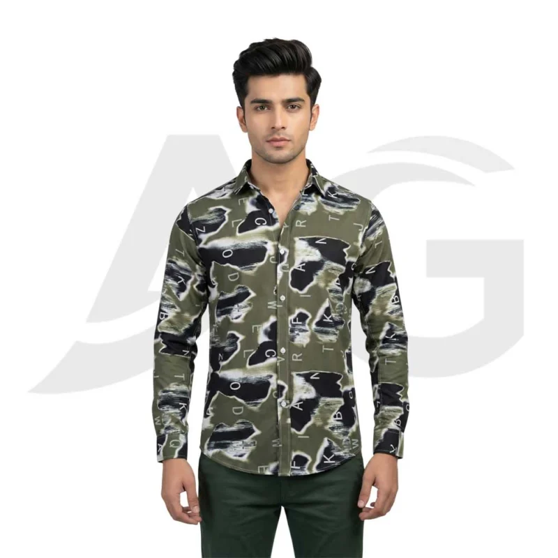 Front view of a man wearing an olive green long-sleeve button-down shirt featuring black and white abstract brushstrokes and scattered typography