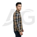 Side profile view of a man in a brown and black checkered shirt, showcasing the sleeve fit and side hem.