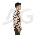 Right side profile view of a man wearing a beige abstract letter print long-sleeve shirt, showcasing the sleeve fit and curved hemline.