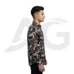 Right side profile view of a man wearing a brown abstract letter print long-sleeve shirt, showcasing the tailored sleeve fit and curved hemline.