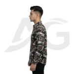 Left-facing side view of a man in a dark brown graphic print casual shirt with scattered letters and brushstrokes.