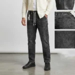 Male model wearing men's charcoal black denim pants featuring a distinctive front leg seam and contrast rope drawstring, alongside detail insets of the pocket and denim texture.