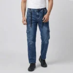 Male model wearing men's blue acid wash denim cargo pants featuring a front vertical seam, side utility pockets, and a black drawstring.