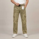 Male model wearing men's khaki olive acid wash denim cargo pants featuring a front vertical seam, side utility pockets, and a black drawstring.
