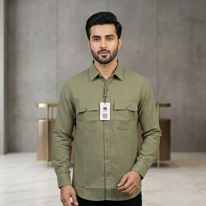 Male model wearing a men's olive green textured long-sleeve button-down shirt with dual chest pockets and a standard collar.