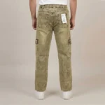 Back view of a male model wearing khaki acid wash denim cargo pants, showing an elastic waistband and classic rear patch pockets.