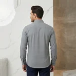 Back view of a male model wearing a fitted grey textured long-sleeve shirt, showing the back yoke and tailored fit.