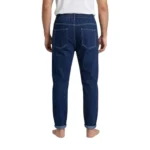 Back view of men's dark blue baggy jeans showing a loose fit, elastic waistband, and rear patch pockets with contrast stitching.