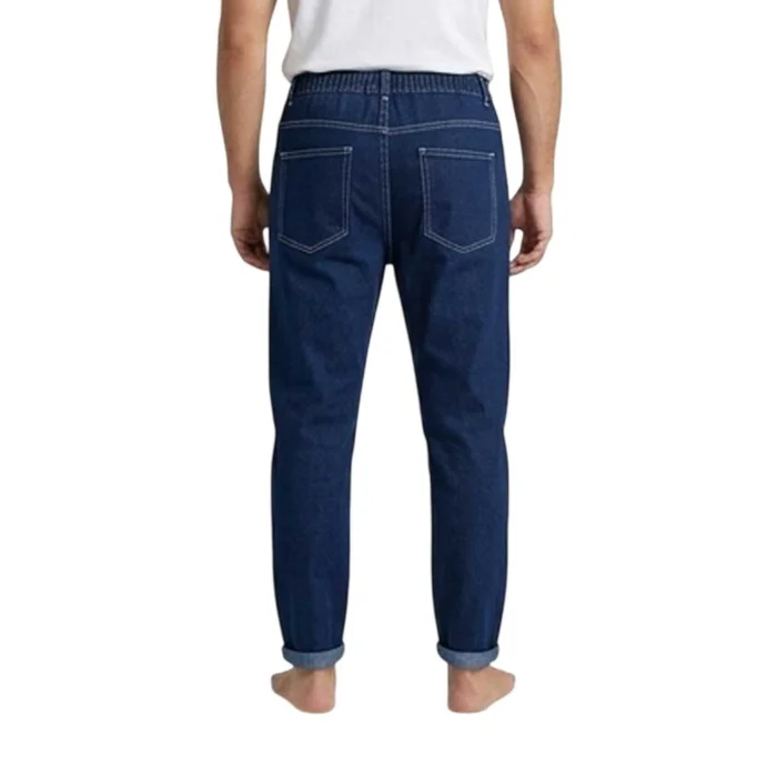 Back view of men's dark blue baggy jeans showing a loose fit, elastic waistband, and rear patch pockets with contrast stitching.