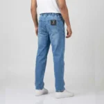 Male model showing the back and side profile of blue denim cargo pants, highlighting the side cargo pockets and regular fit.