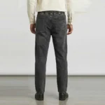 Back view of a male model in dark grey relaxed fit denim pants, showing an elastic waistband and classic rear patch pockets.