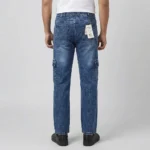 Back view of a male model wearing blue acid wash denim cargo pants, showing an elastic waistband and rear patch pockets.