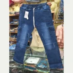 Men's dark blue denim cargo pants held up, displaying the front elastic waist, white integrated drawstring, dual cargo pockets, and subtle distressed details.