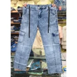 Light blue acid wash denim cargo pants held up in a retail store, clearly displaying the black drawstring, front vertical seams, and side cargo pockets.