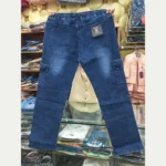 Back view of men's dark blue denim cargo pants held up, showing the flexible elastic waistband, rear pockets with a size tag, and side cargo pockets.