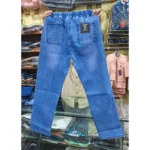 Back view of men's medium wash blue denim cargo pants highlighting back pockets, elastic waist, and garment-dyed finish.