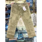 Back view of khaki denim cargo pants held up in a retail setting, highlighting the gathered elastic waist, rear pockets with tags, and side cargo pockets.