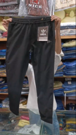 Men's black Adidas trousers in Pakistan featuring a slim fit design, elasticated drawstring waist, and subtle side branding.