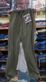 Men's olive green Nike trousers in Pakistan featuring a slim fit, side stripes, and elastic drawstring waist.
