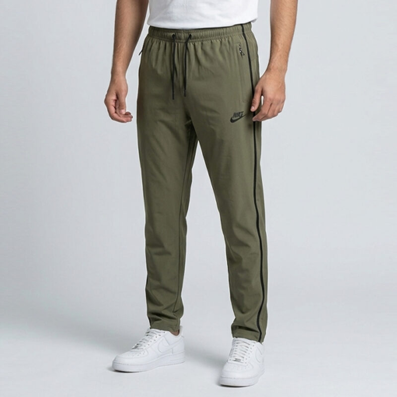 Men's olive green Nike trousers in Pakistan featuring a slim fit, side stripes, and elastic drawstring waist.