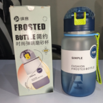 Navy blue frosted 720ml water bottle with pop-up straw lid and carry strap