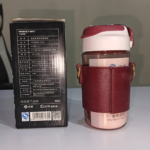 570ml red water bottle with glass body, protective sleeve and adjustable strap