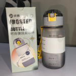 Grey frosted 720ml sports water bottle with pop-up straw lid and yellow strap