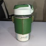 570ml green glass water bottle with protective sleeve and adjustable strap